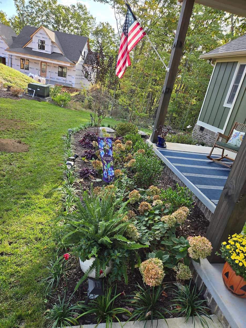 Fresh dark mulch and crisp edging around front yard plant beds in Chattanooga, TN