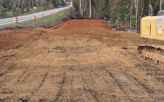 A wide graded building pad shaped and compacted on a South Carolina site