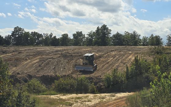 Wide open graded ground prepared for an arena base