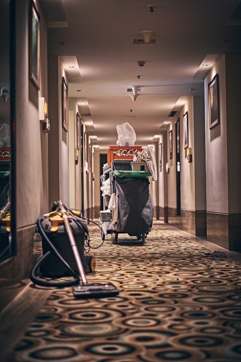 Commercial cleaning cart and equipment in professional business facility corridor