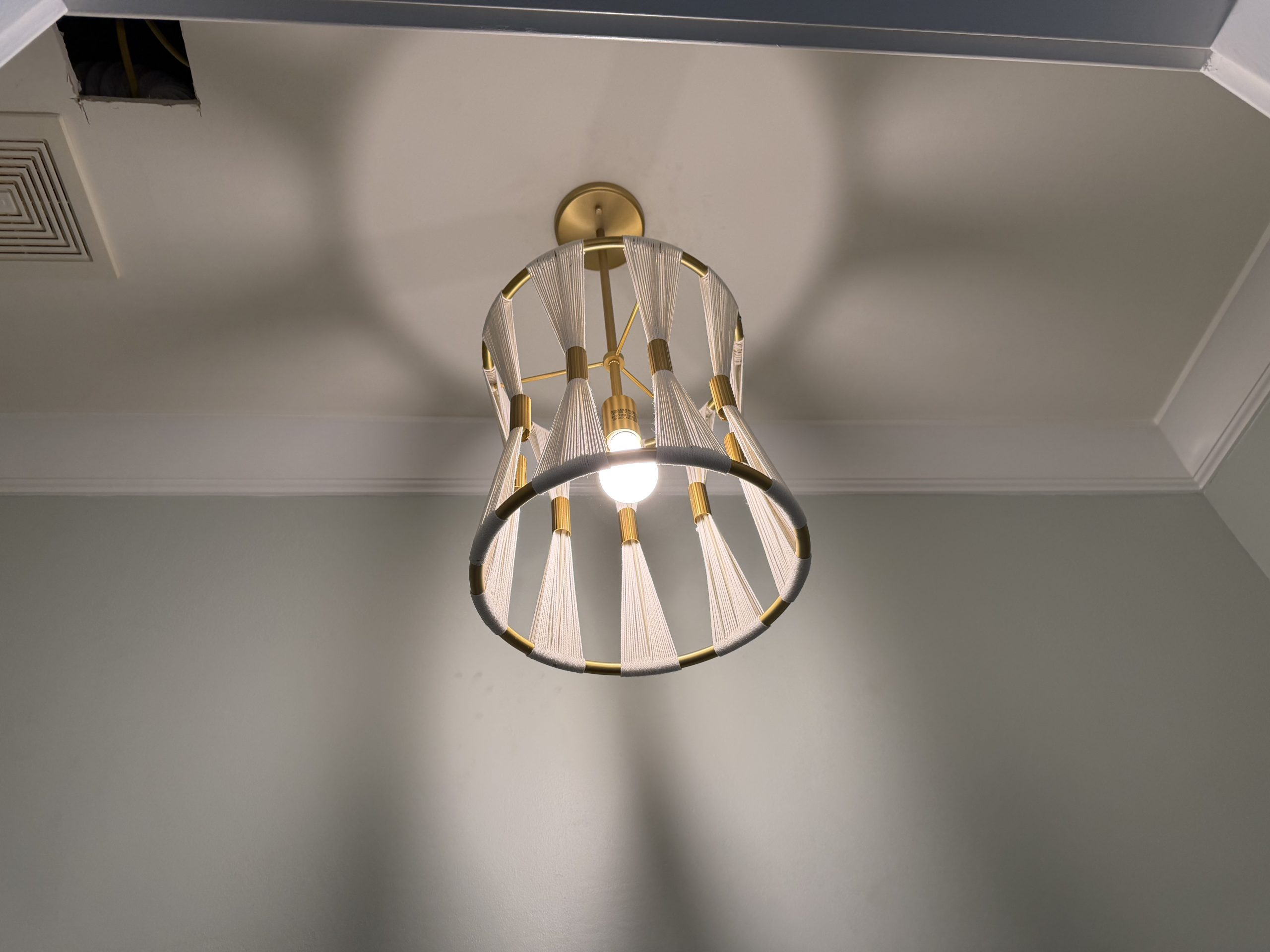 Custom woven brass and rope artisan pendant light installed by Wavecrest Electric