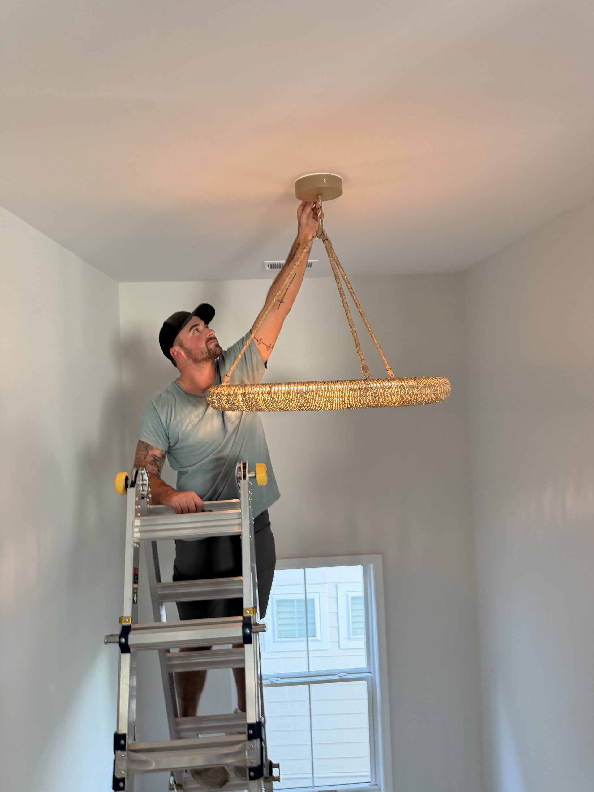 Cole Nelson installing lighting fixture, Owner of Wavecrest Electric LLC