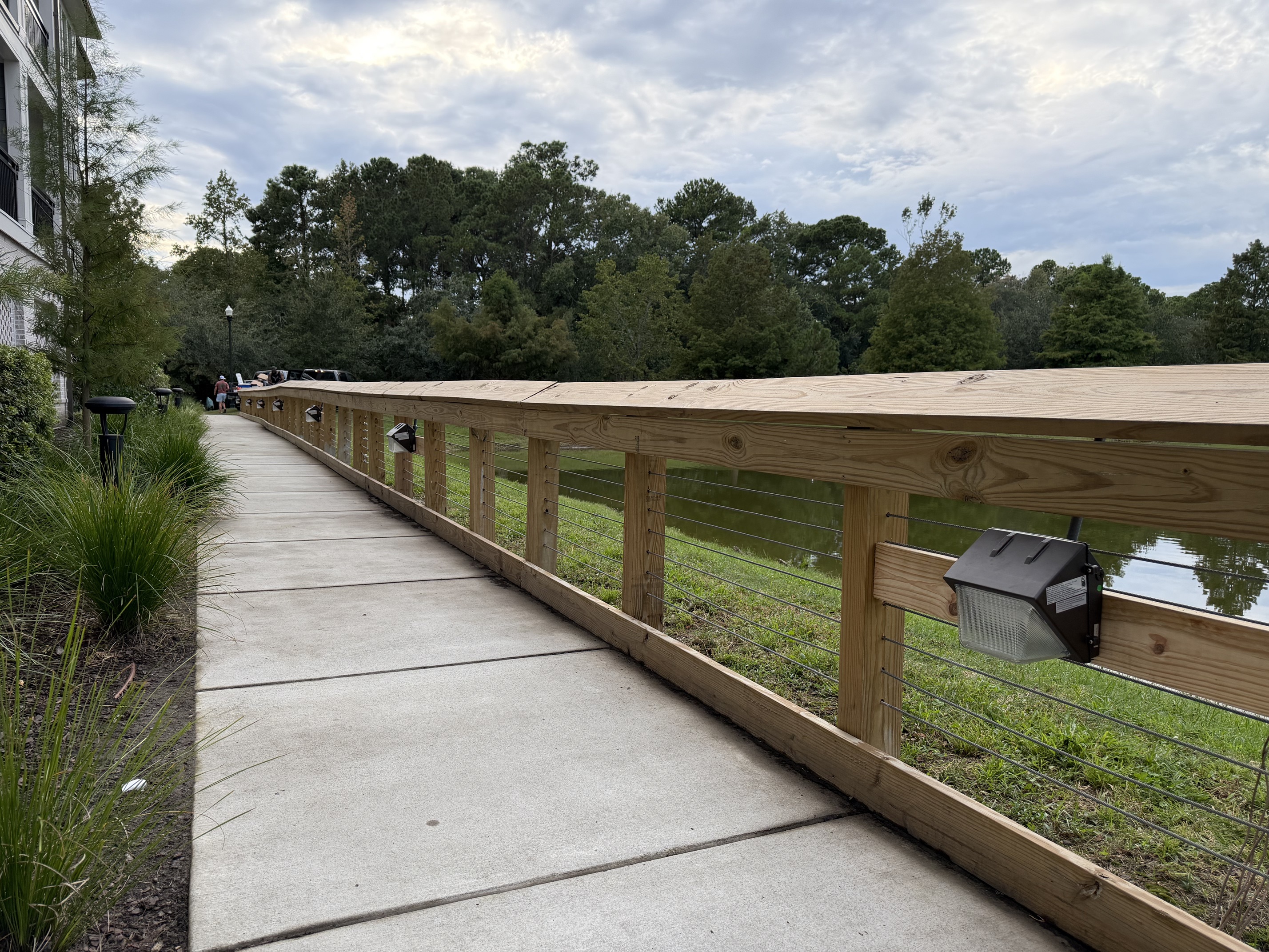 Commercial boardwalk safety and landscape bulkhead lighting installation along water by Wavecrest Electric