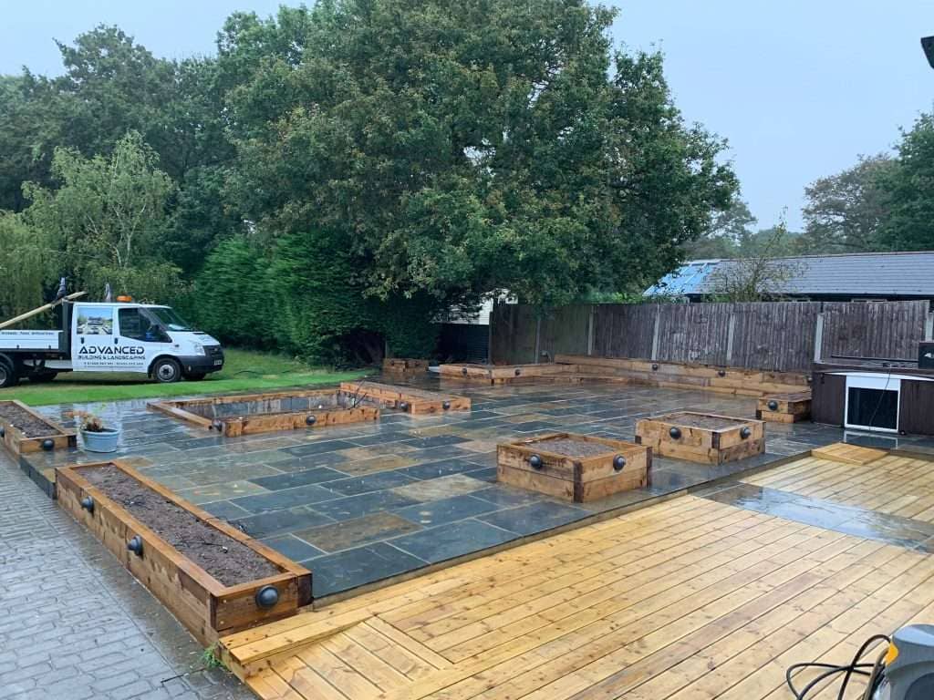 Garden landscaping project with decking and slate pathway in Basildon