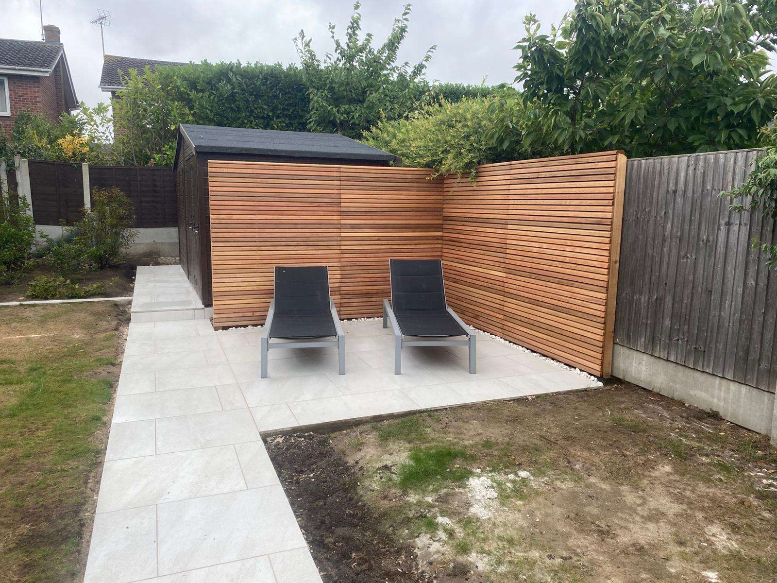 Outdoor lounge furniture seating area on porcelain patio in Hadleigh