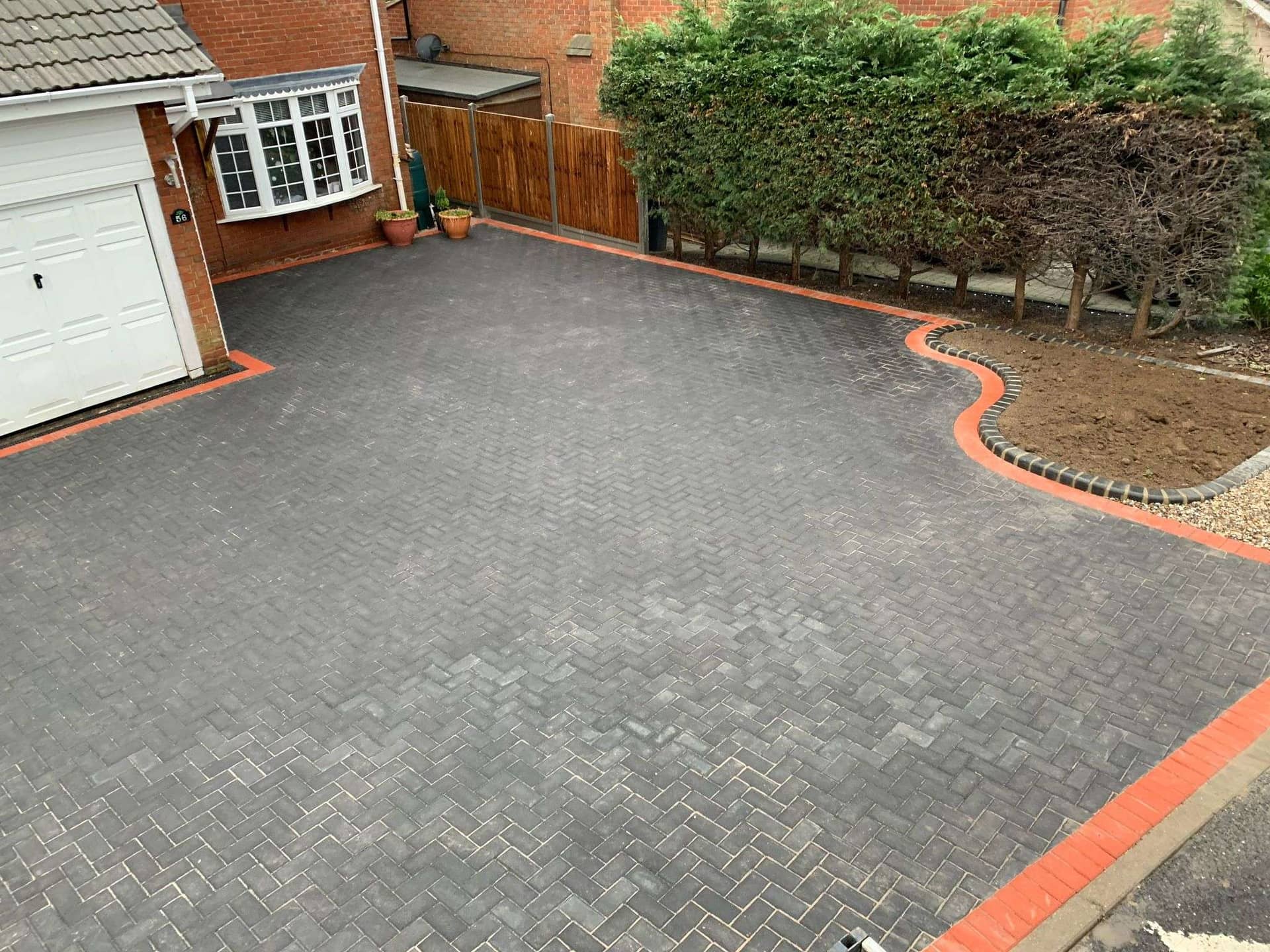 Paved driveway with red brick border in front of house in Essex