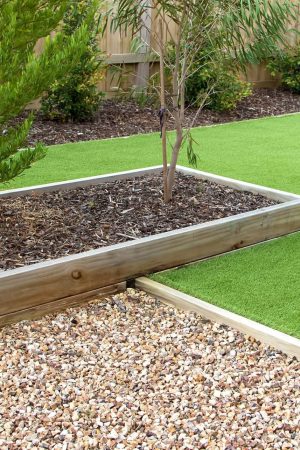 Artificial grass with decorative gravel borders