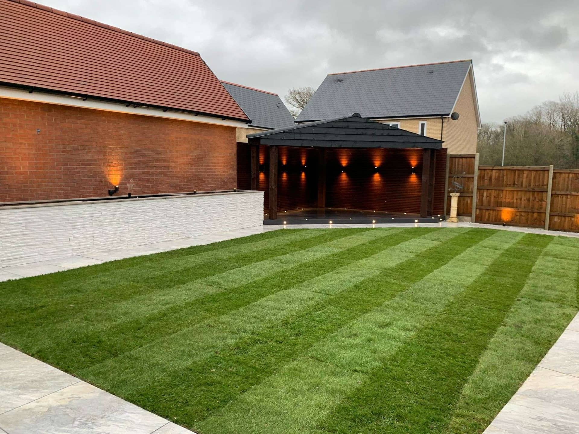 Striped lawn and timber garden building structure in Billericay makeover