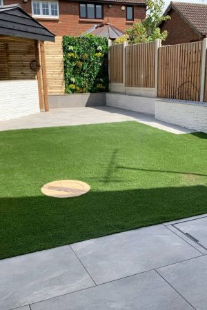 Artificial grass lawn with integrated patio in Basildon