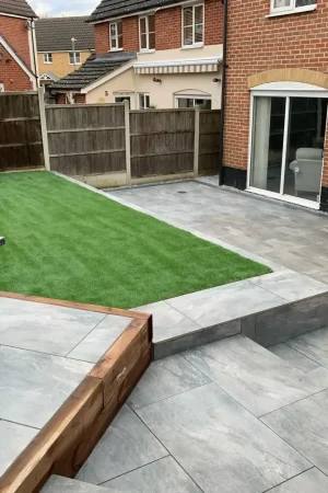 Backyard artificial grass lawn with paving stones in Essex