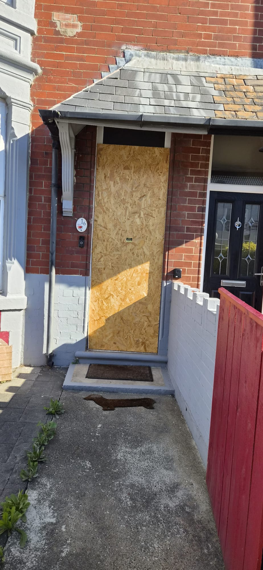 Boarded entrance before replacement with a modern secure door