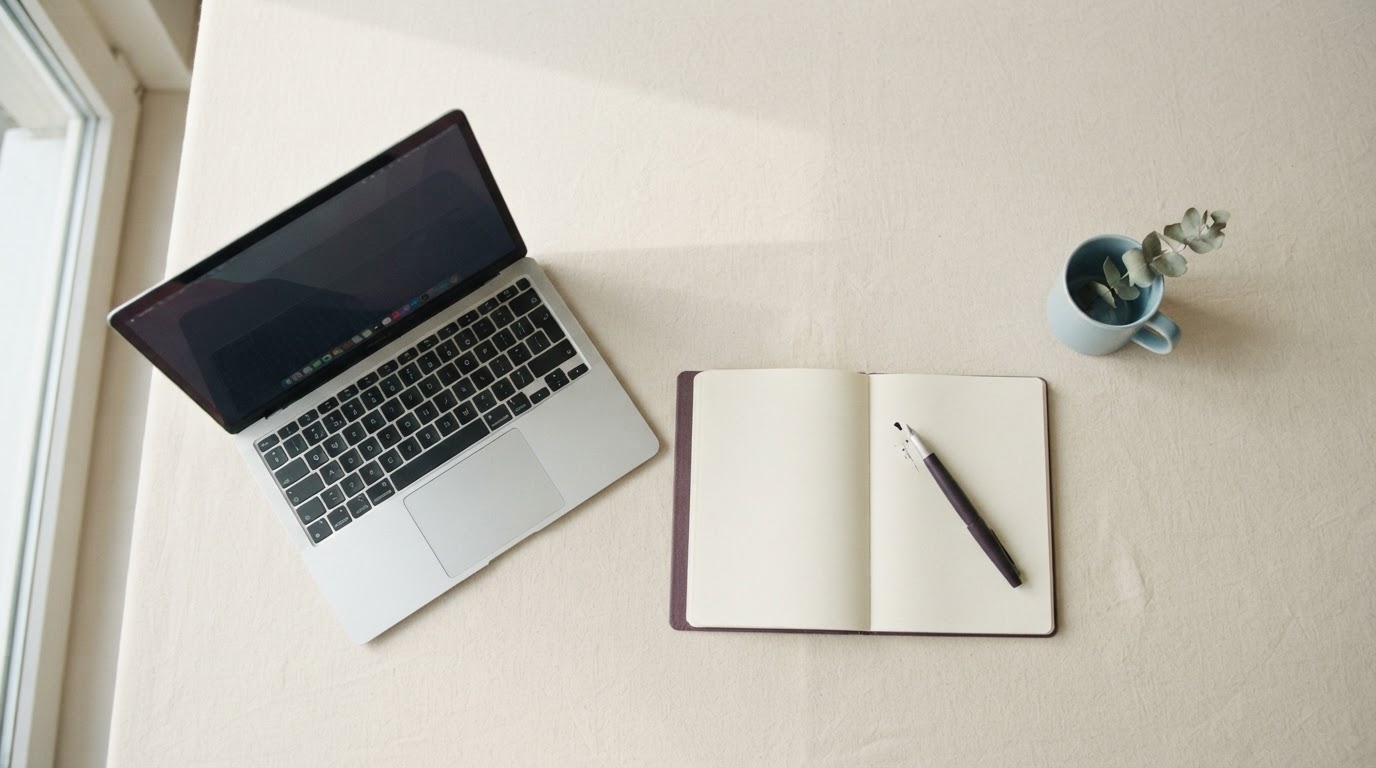 Calm desk with an open notebook and fountain pen in soft natural light