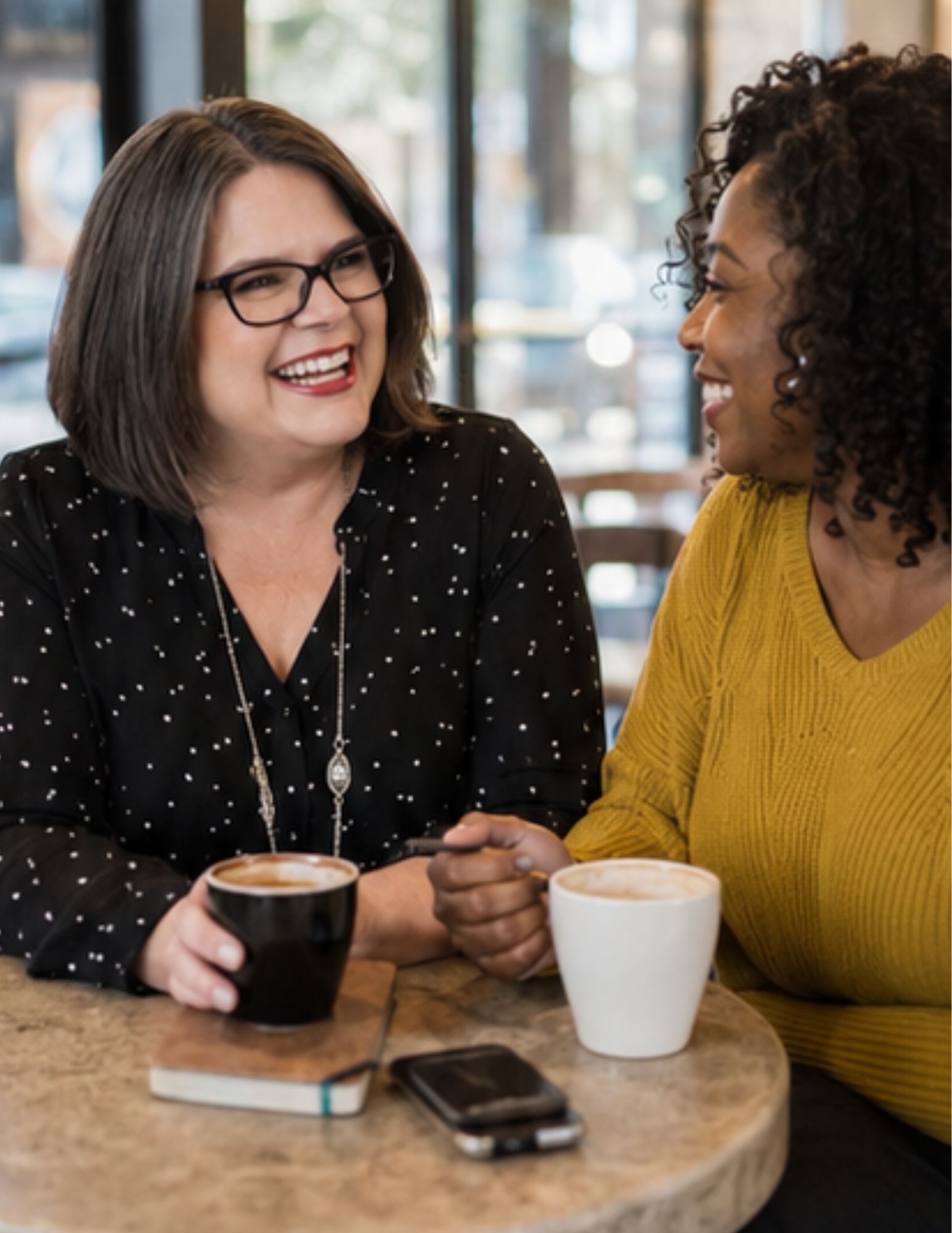 Laurie J. McAleenan collaborating with a client over coffee