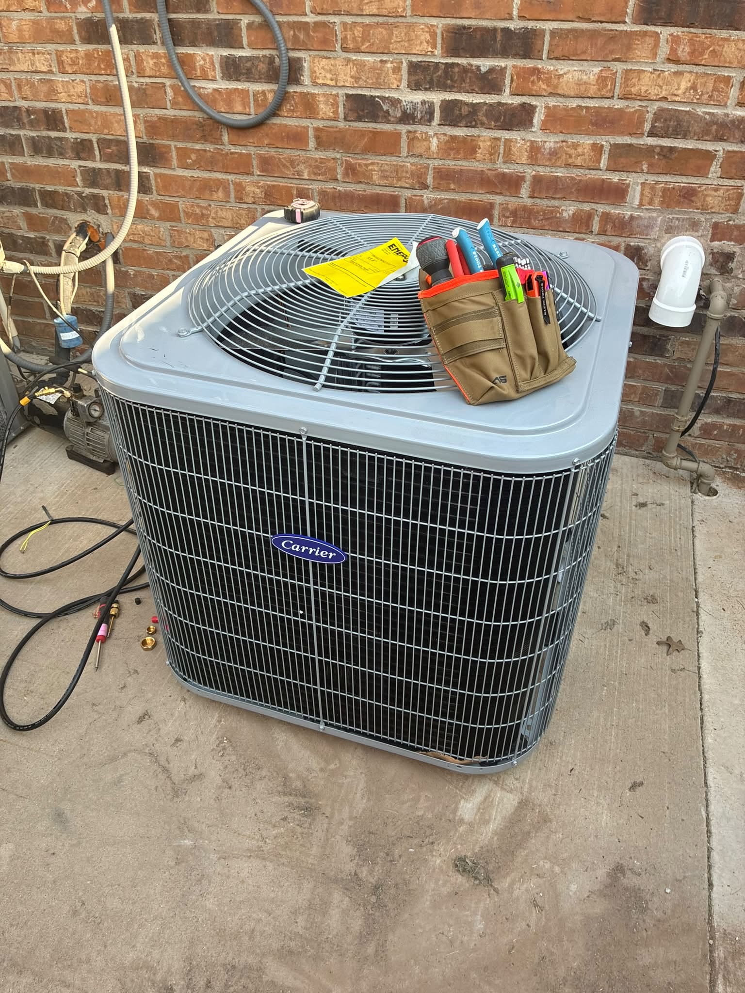 Carrier condenser unit being serviced by a Patrick Heating & Air technician in Amarillo