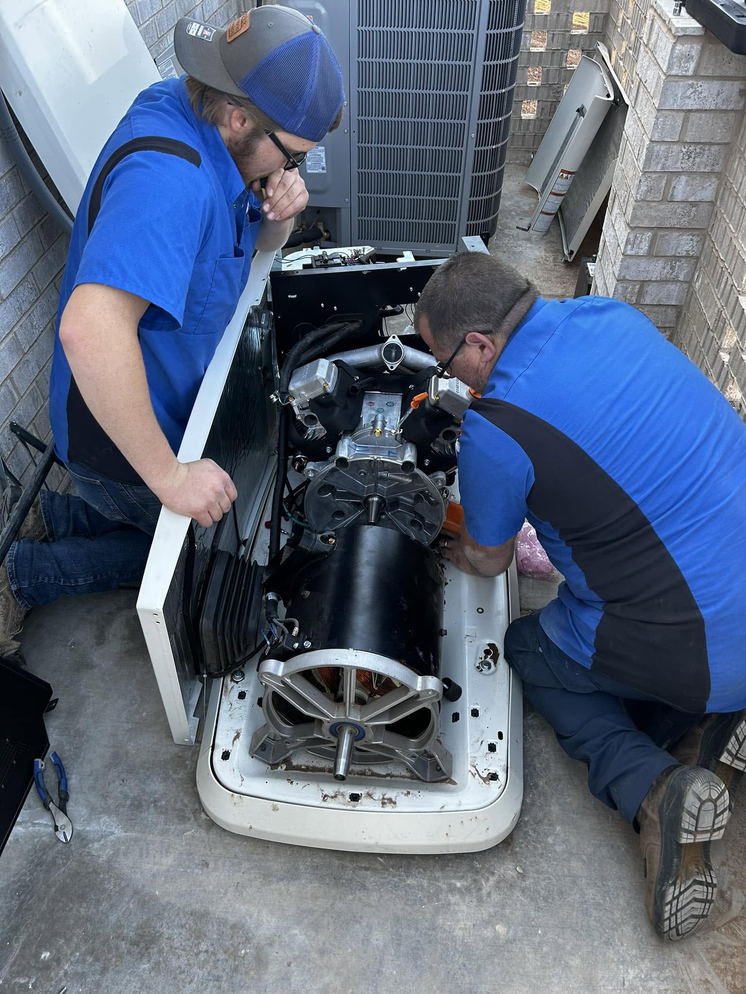 Patrick Electric Service electricians servicing a Generac standby generator motor