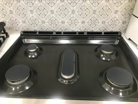 Degreased gas range cooktop and tile