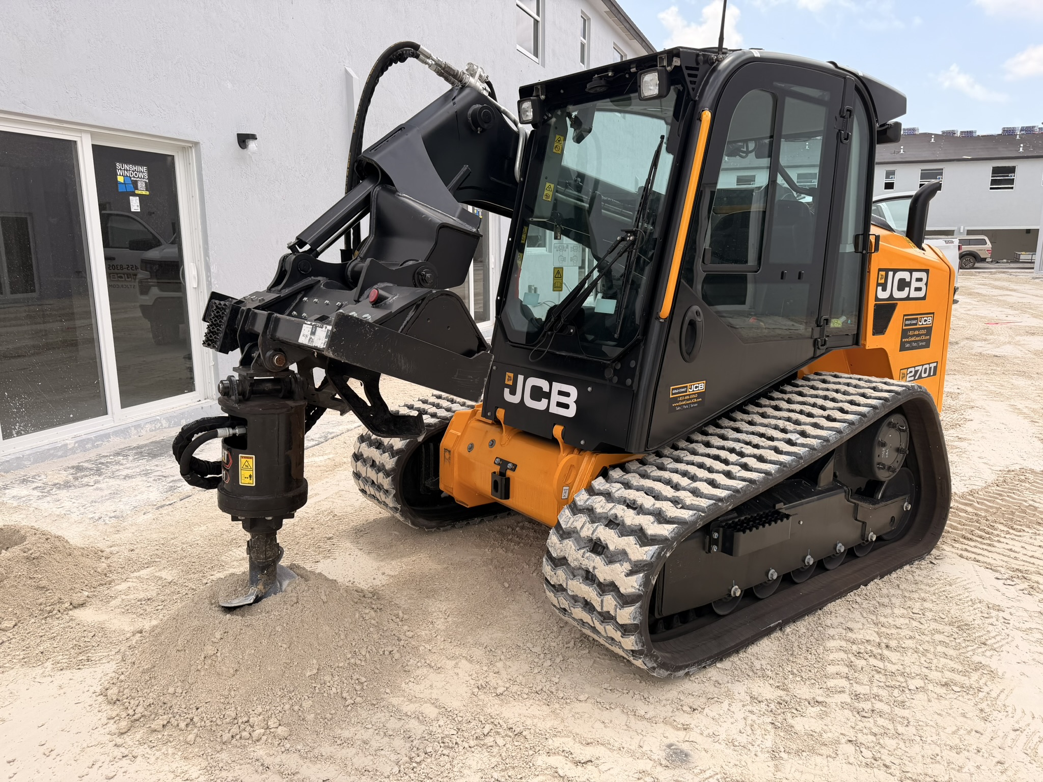 JCB 270T skid steer with auger on Miami jobsite