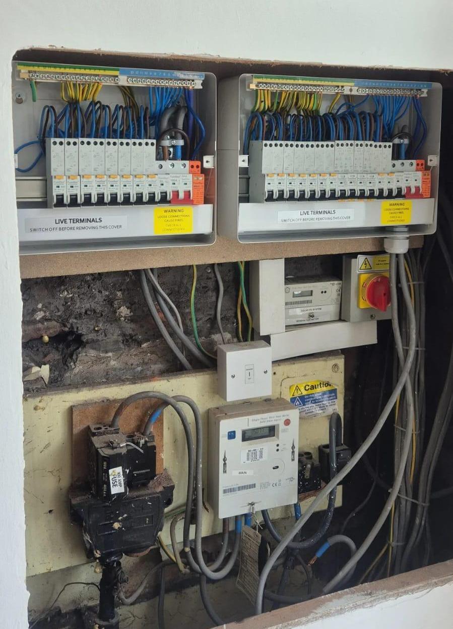 Dual FuseBox metal distribution boards with solar generation meter and rotary isolator in service cupboard