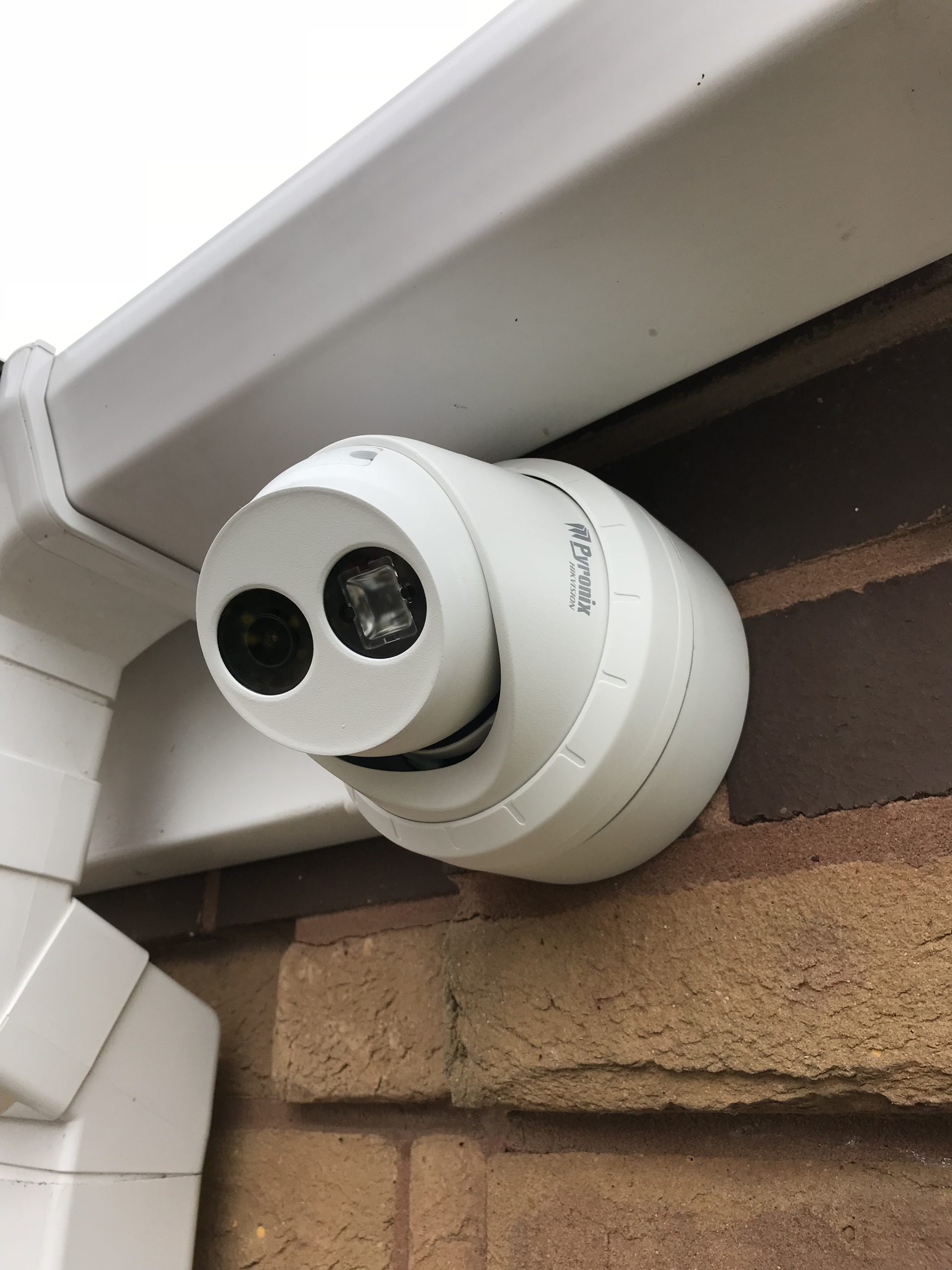 Pyronix Hikvision turret CCTV camera mounted securely under soffit and brickwork