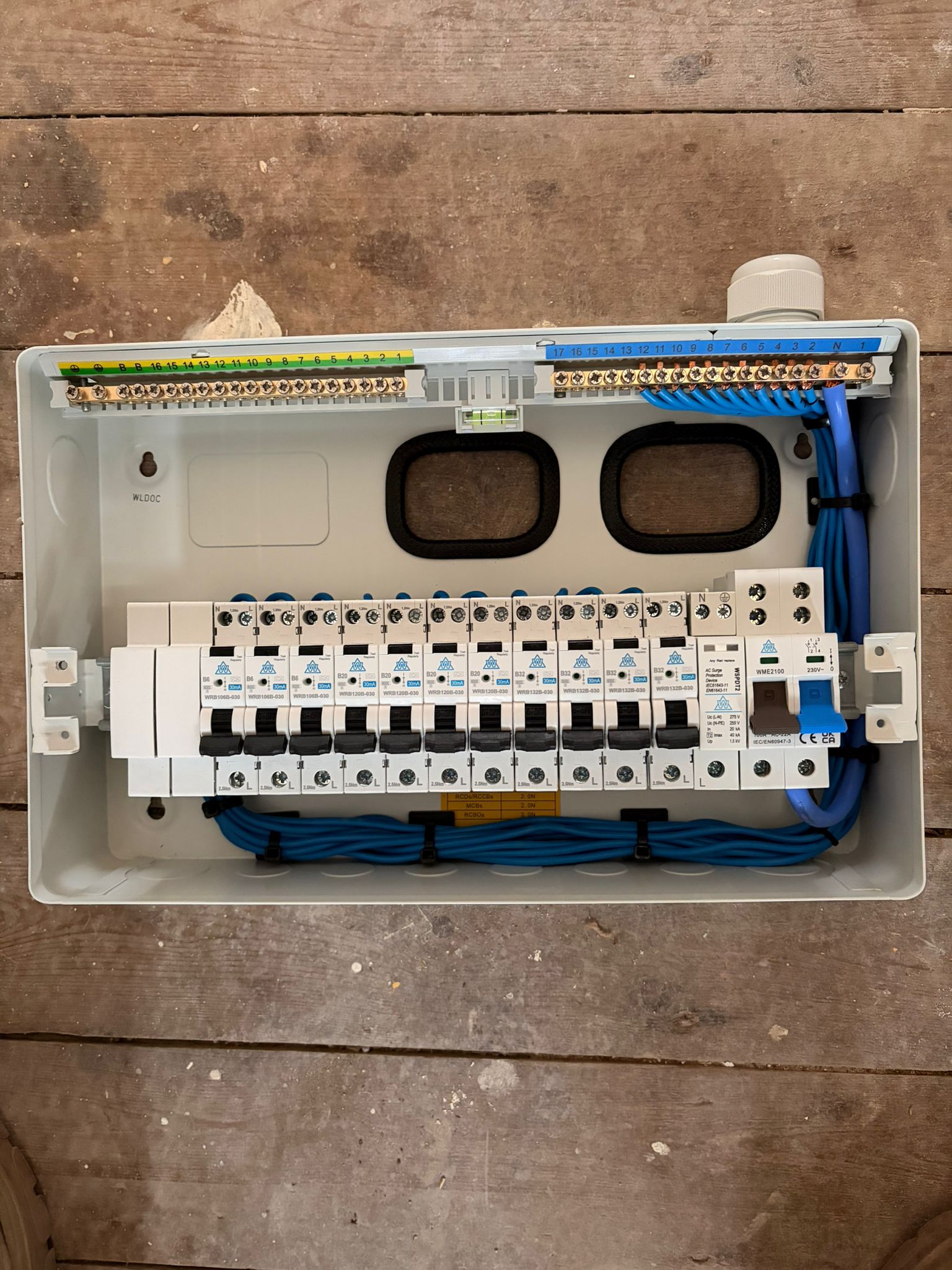 Precision first-fix consumer unit board dressing with RCBOs, Type 2 surge protection device and built-in spirit level