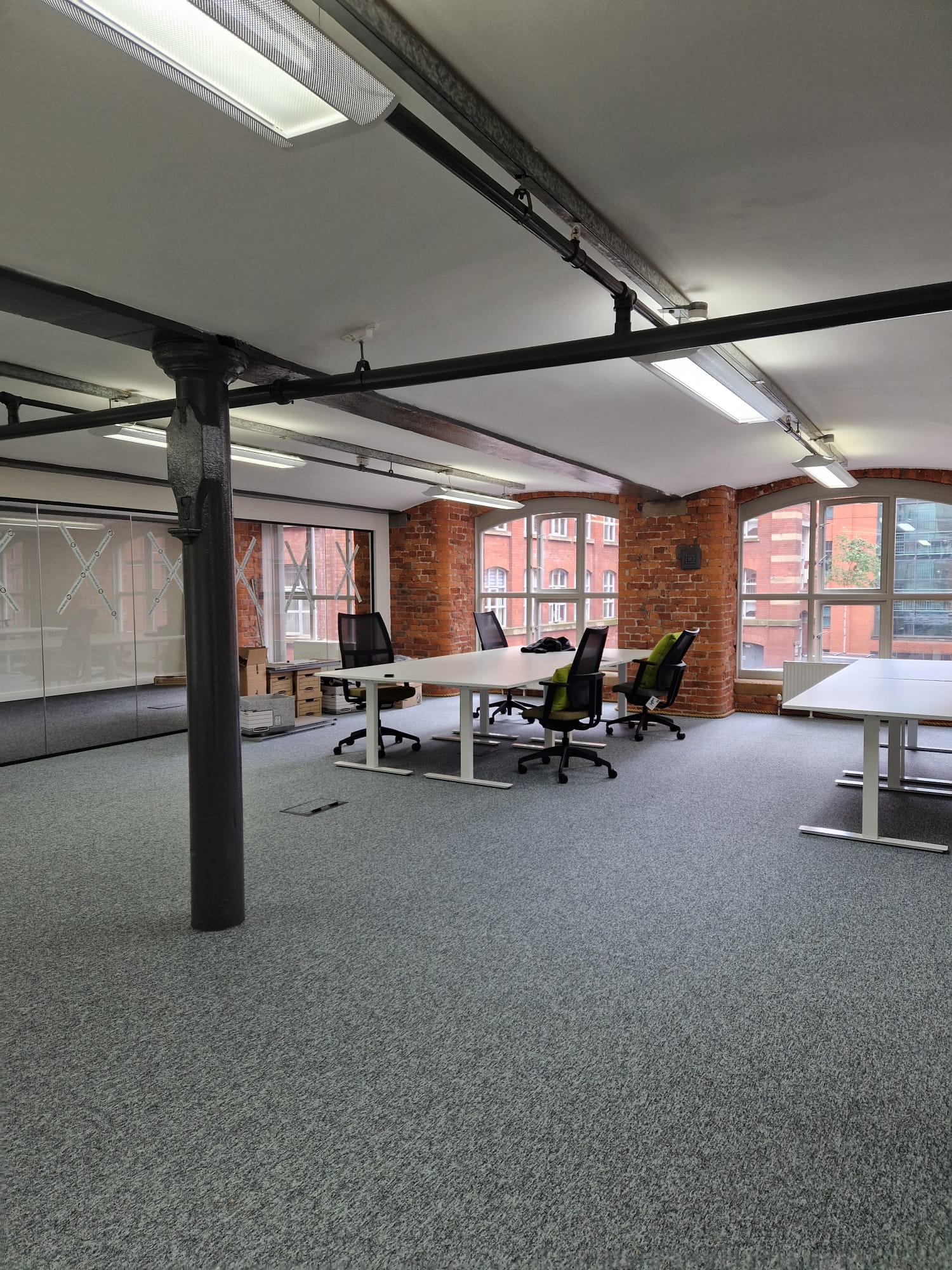 Suspended commercial linear LED lighting fitted in an open-plan office space