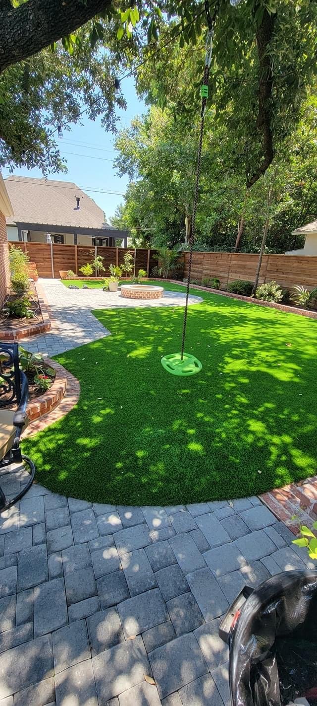 Synthetic turf installed alongside a porch and walkway