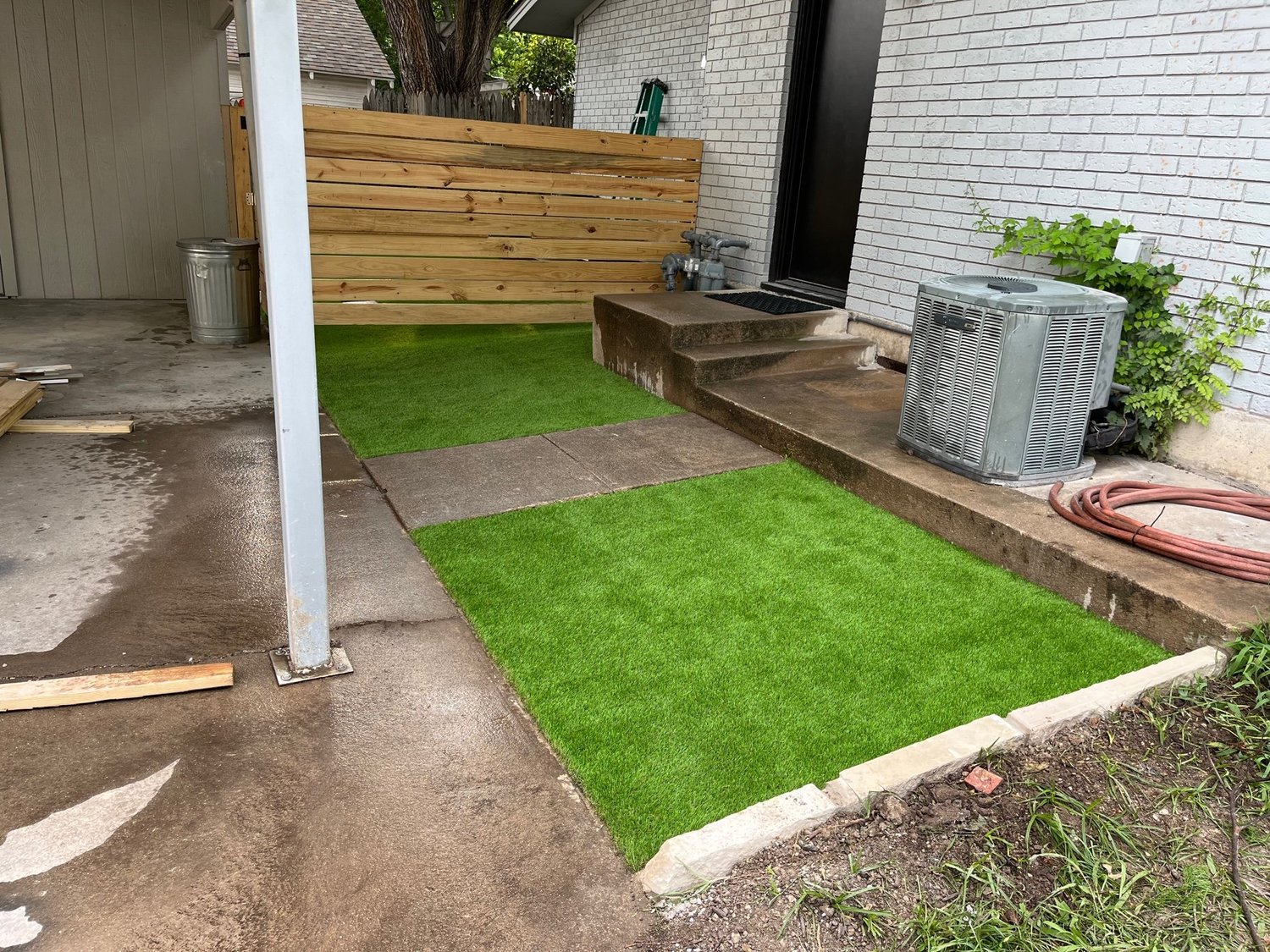 Installed synthetic turf meeting a paved edge