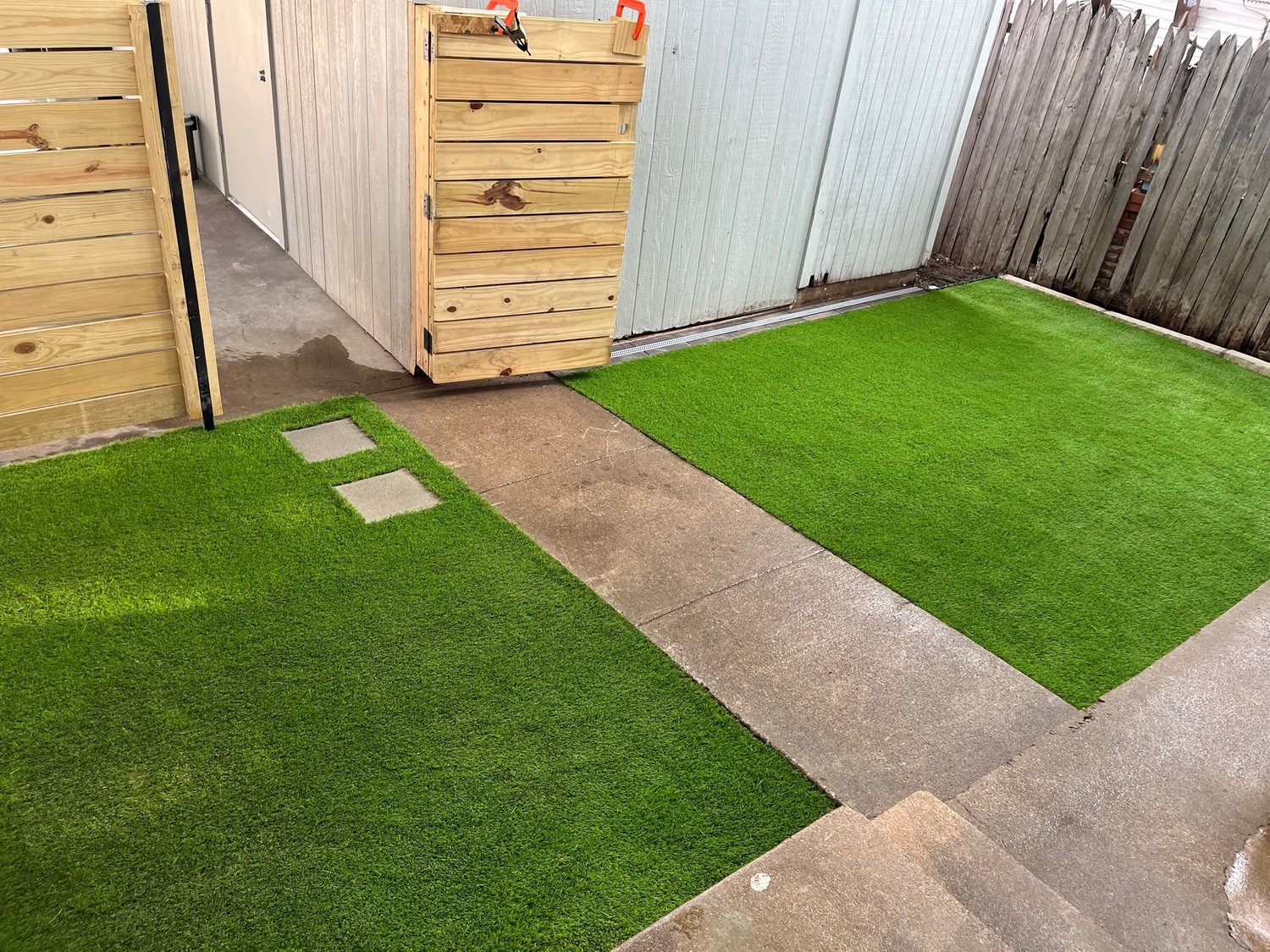 Synthetic turf installed beside a shed and concrete paths