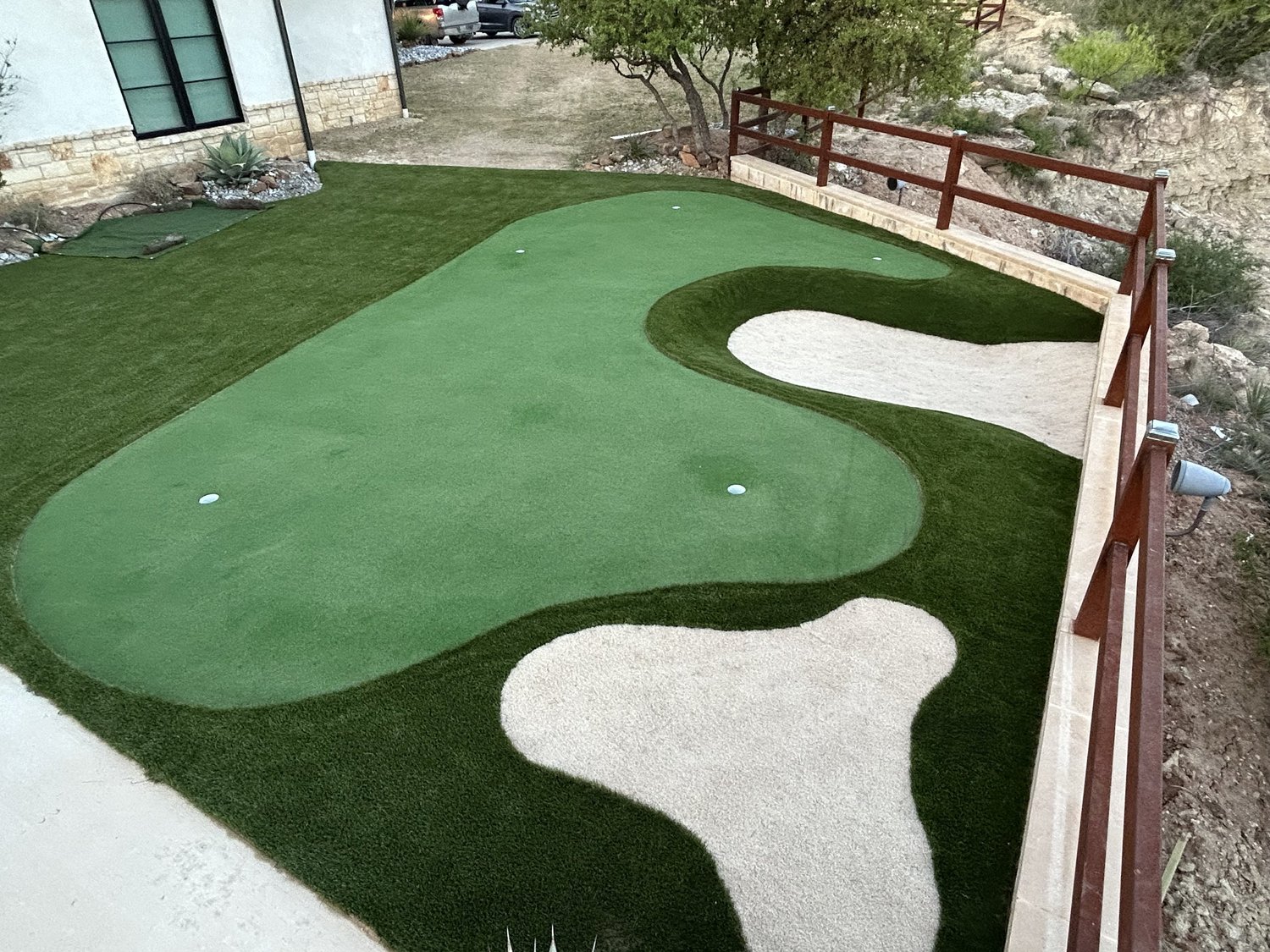 Custom putting green installation with synthetic turf