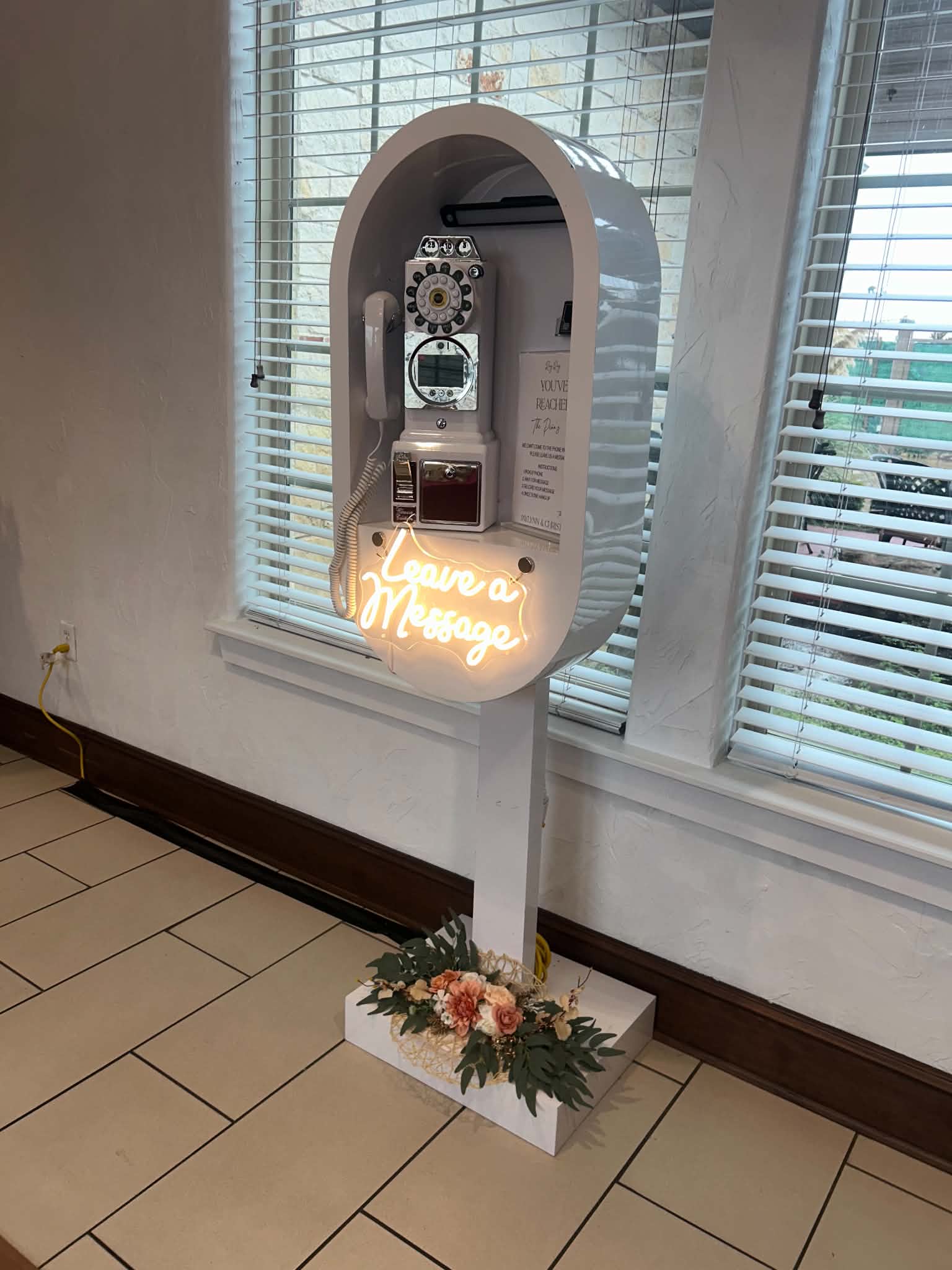 White telephone audio guestbook setup in arch display