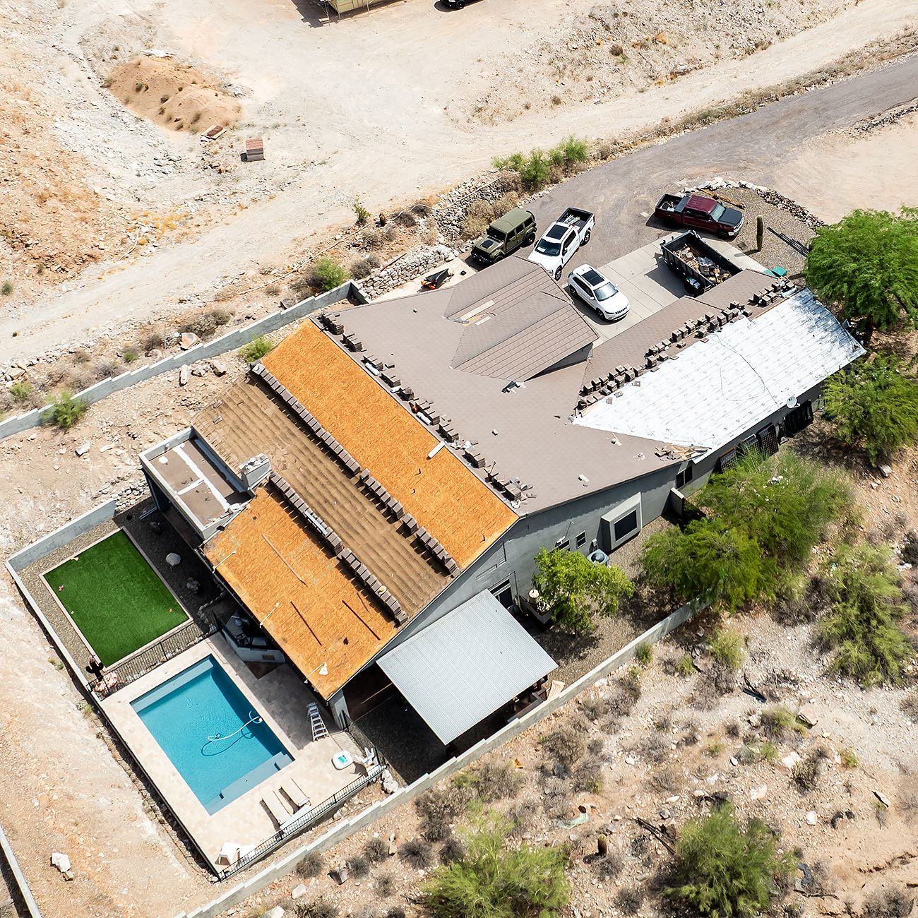 Aerial view of a tile re-roof on a desert home with a pool