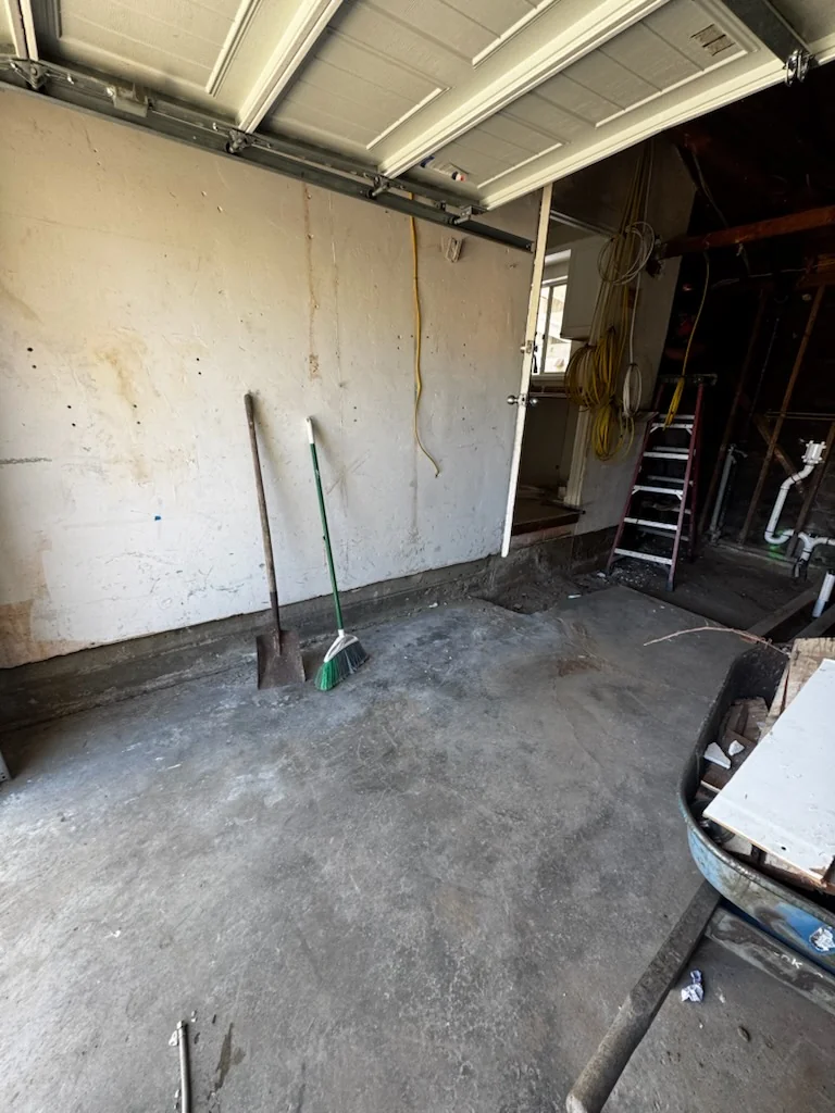 Pacific Beach renovation work area with a cleared floor following debris cleanup.
