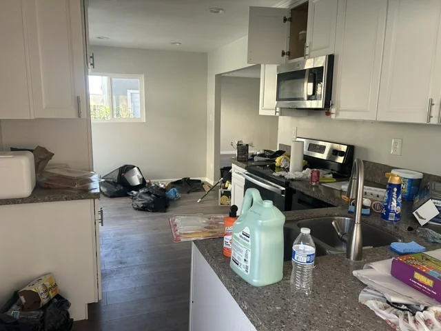 Kitchen counters and surrounding area with loose items before a Chula Vista pre-sale property cleanout.