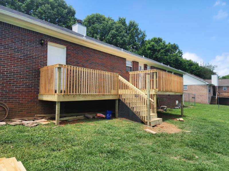 Custom elevated wood back porch with stairs and railings