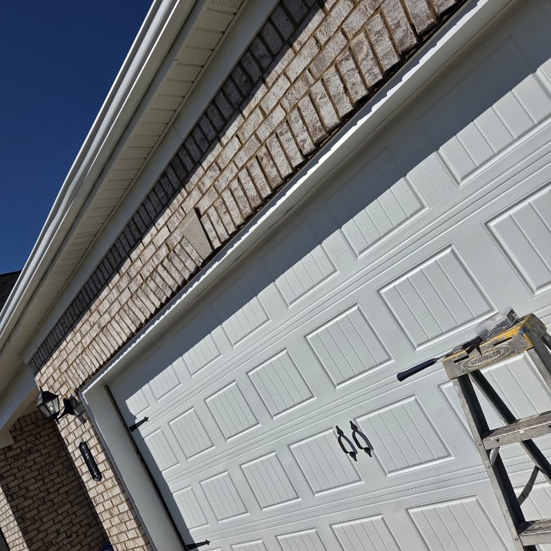 Clean, freshly painted residential garage door with decorative hardware
