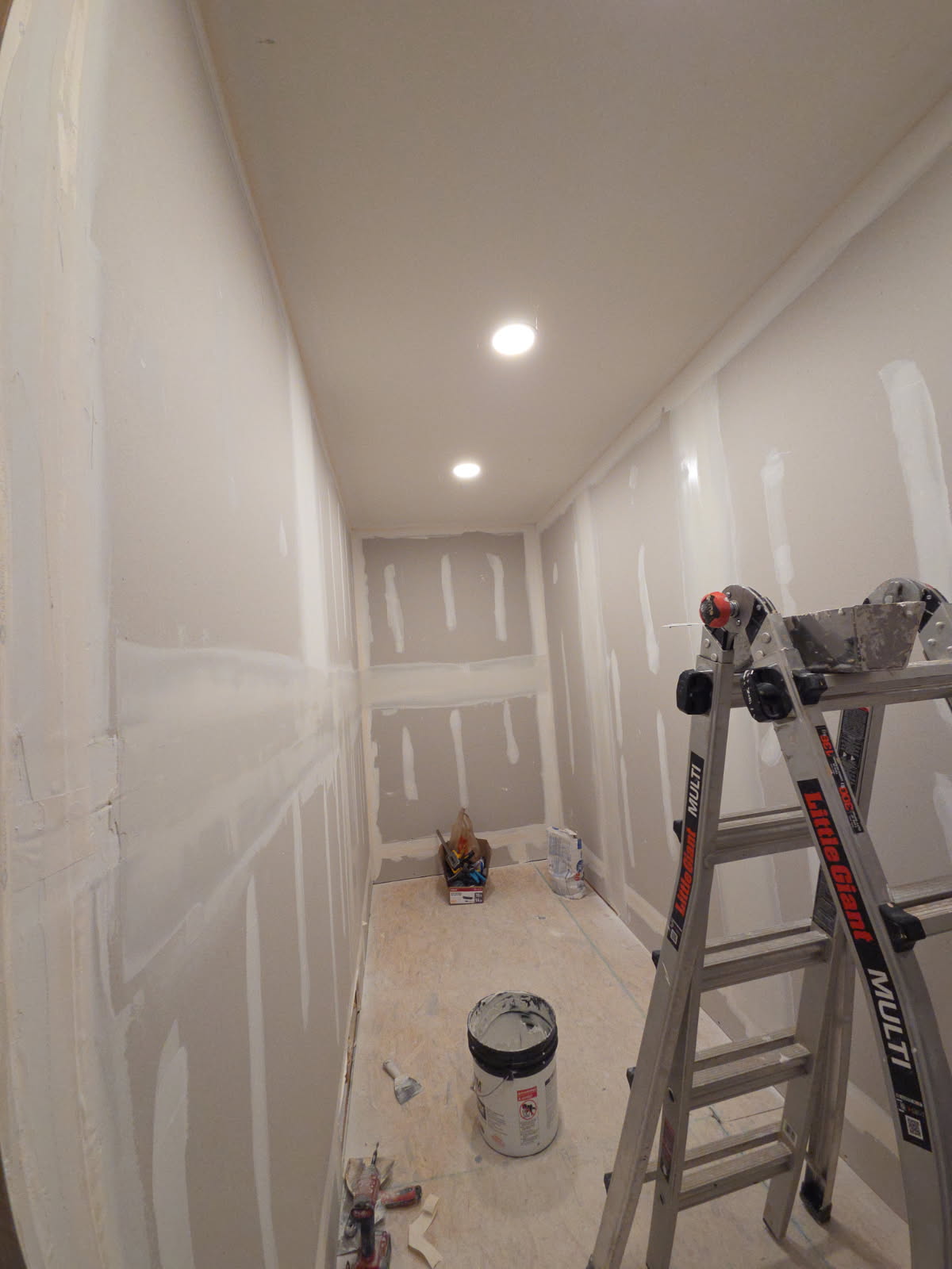 Drywall hallway taped and mudded ready for paint with ceiling recessed lights