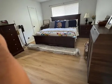 Bedroom cleaned and hardwood floor sanitized by Emma Romero
