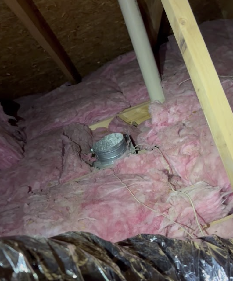 Attic duct boot installation with fiberglass insulation around duct run