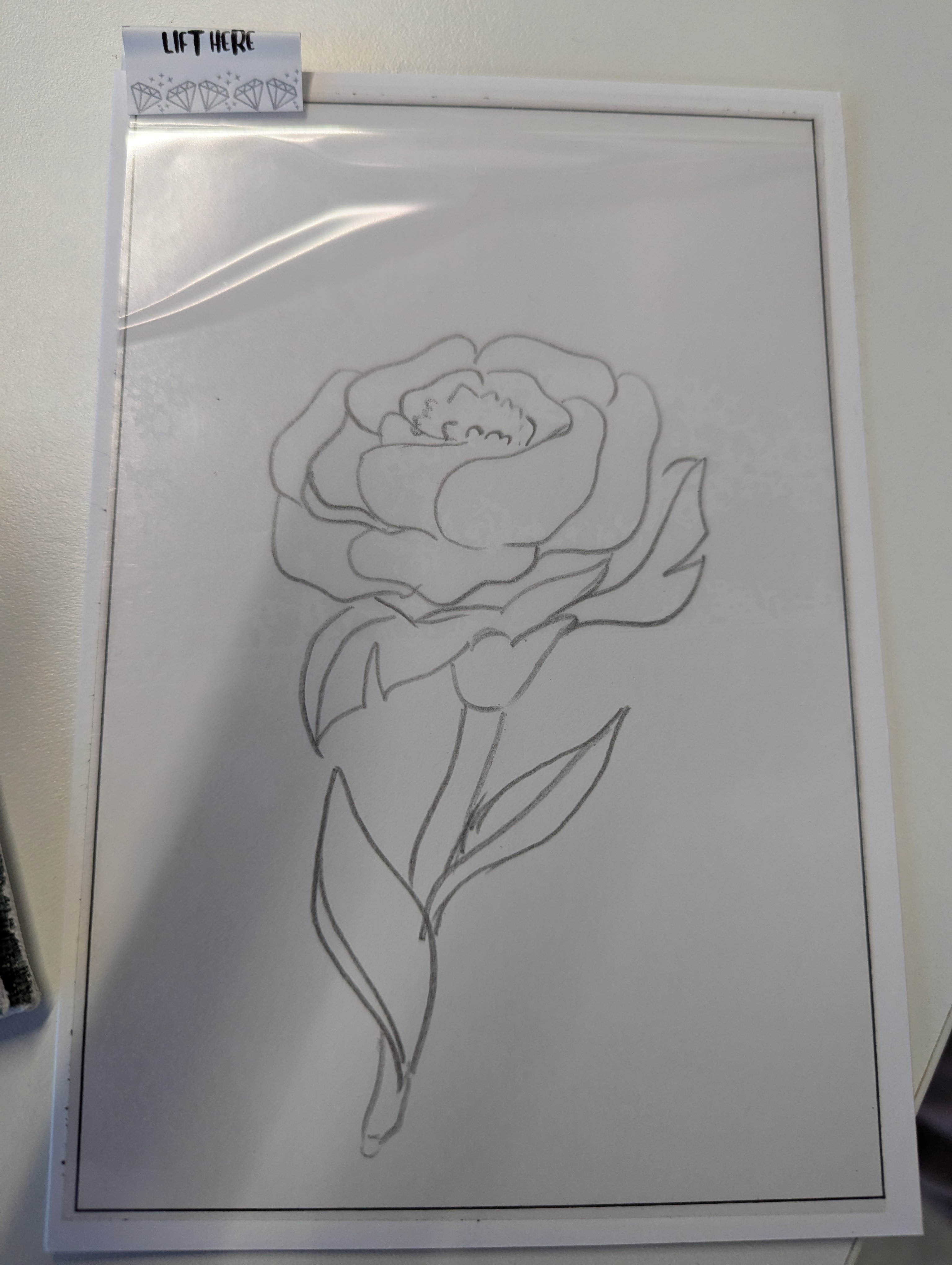 Hand-sketched rose outline on sticky canvas ready for diamond painting