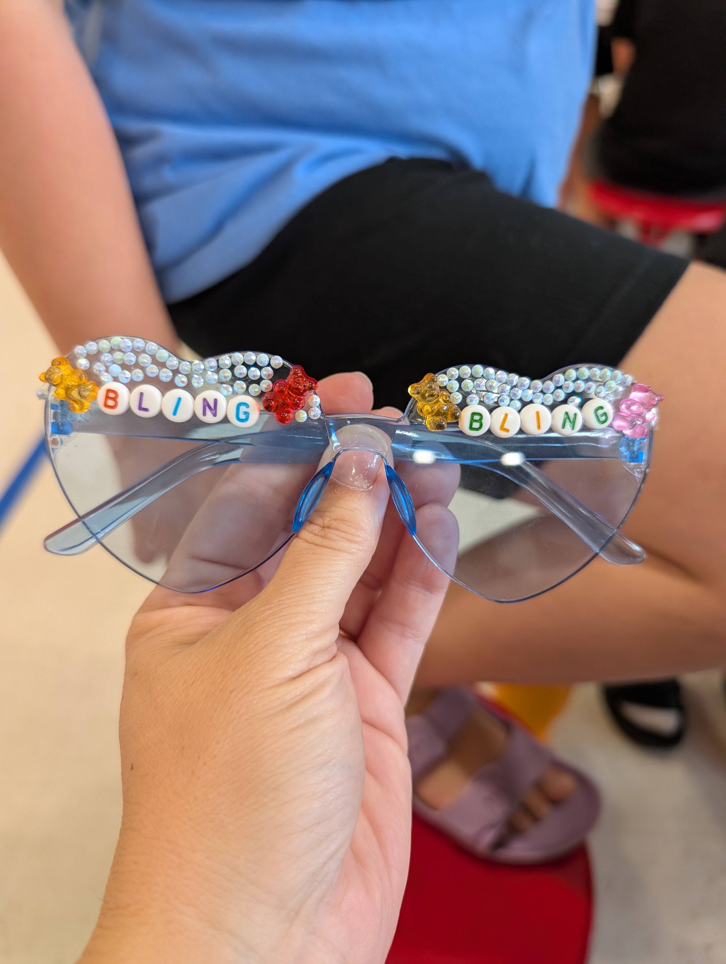 Hand holding custom jeweled BLING sunglasses