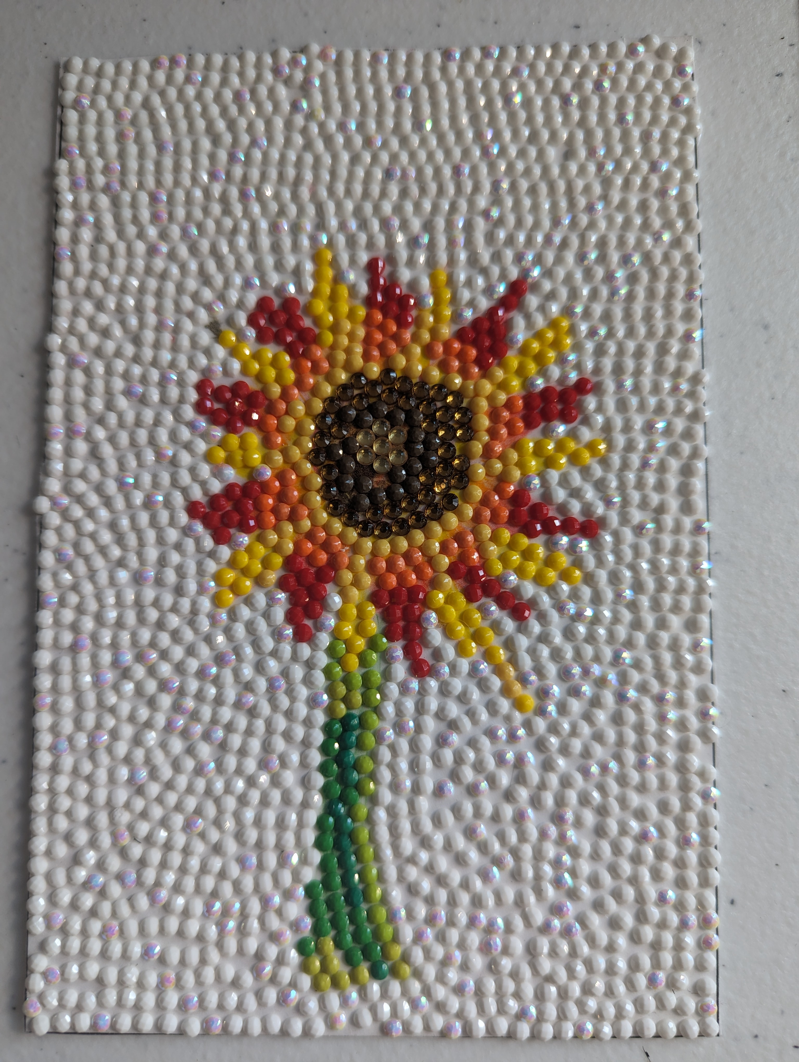Finished sparkling sunflower diamond painting with white gem background
