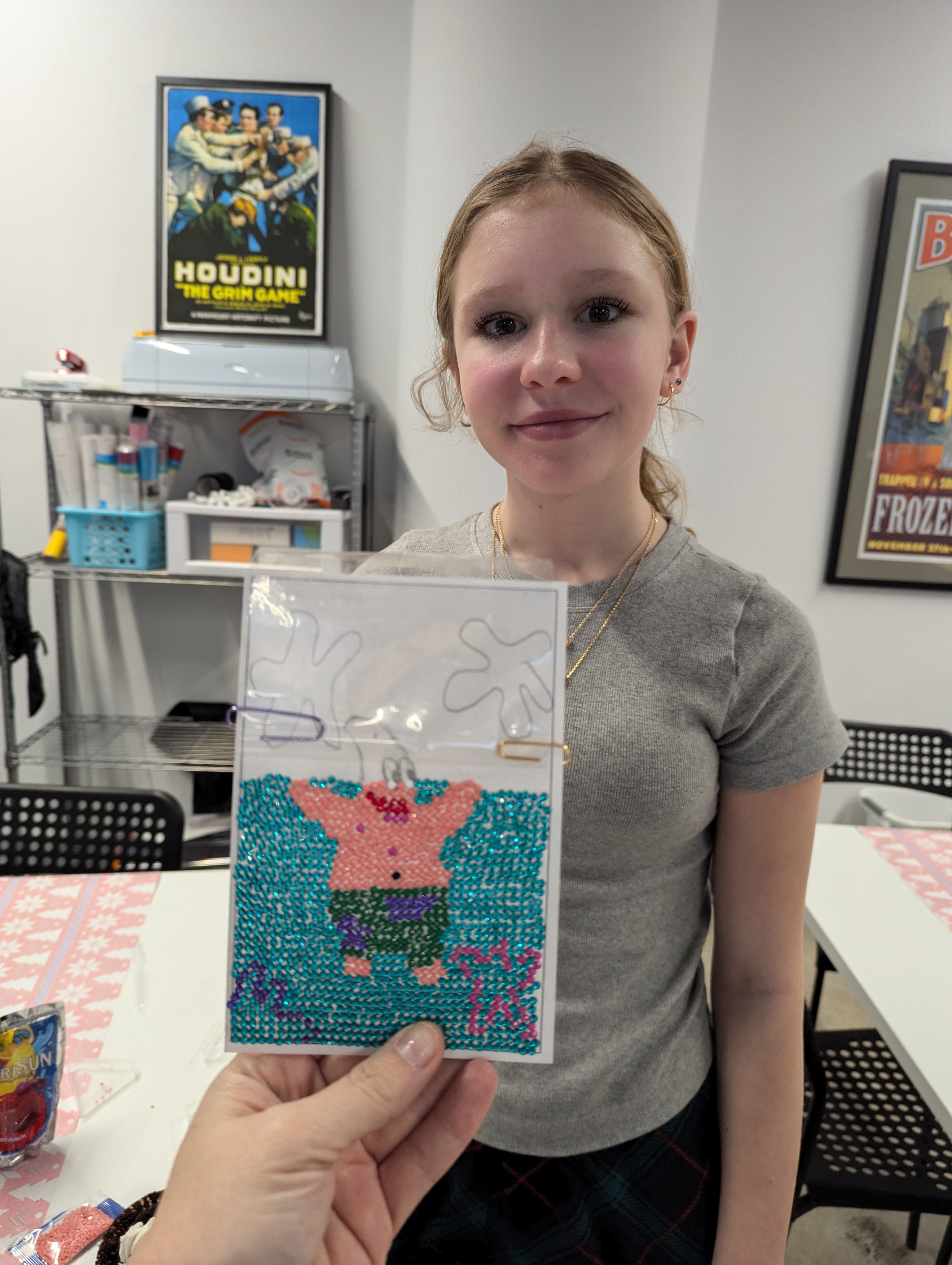 Student proudly holding her custom Patrick Star freehand diamond painting