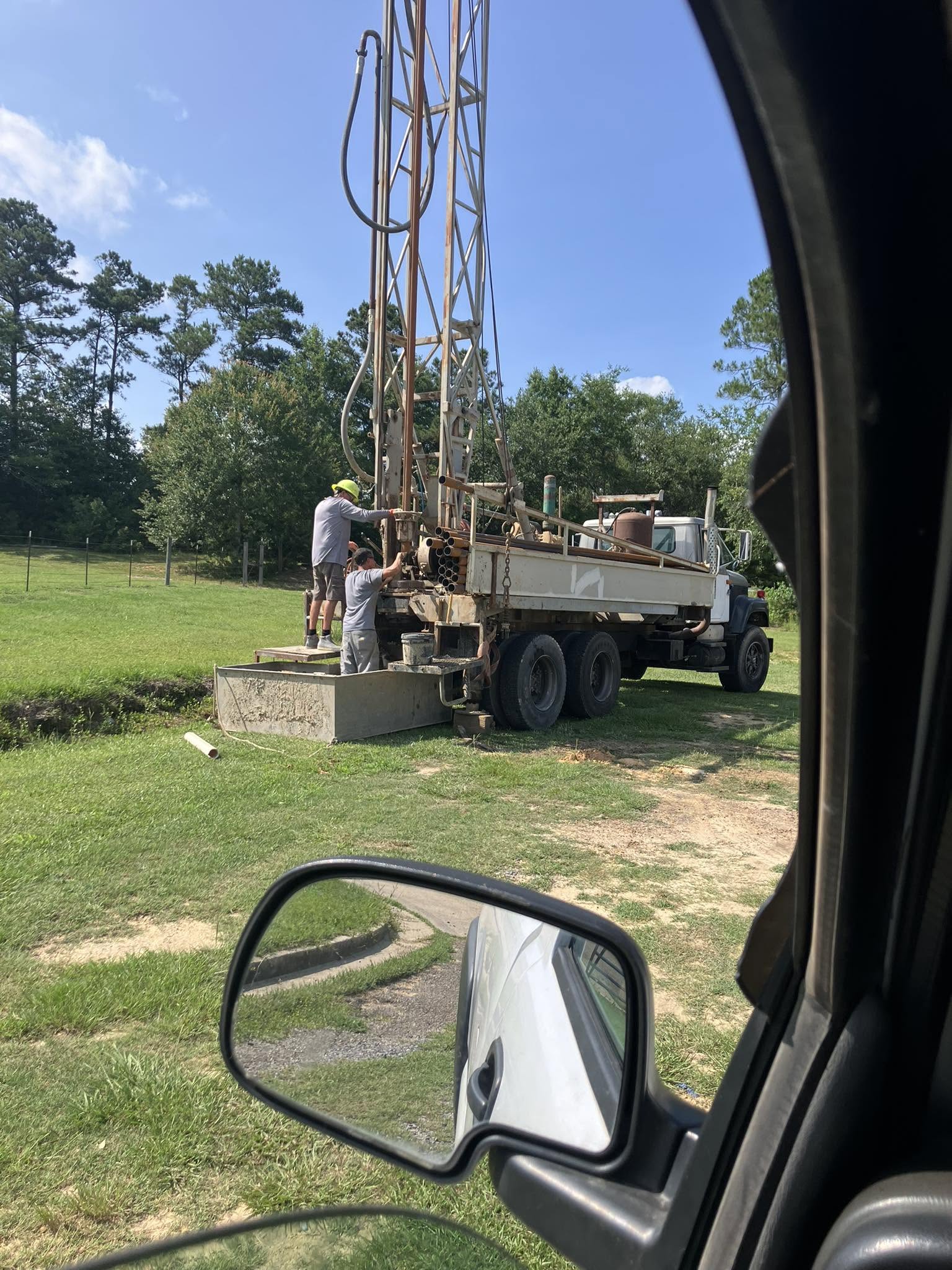 Truck-mounted drilling rig drilling a new water well in a field on the Mississippi Gulf Coast