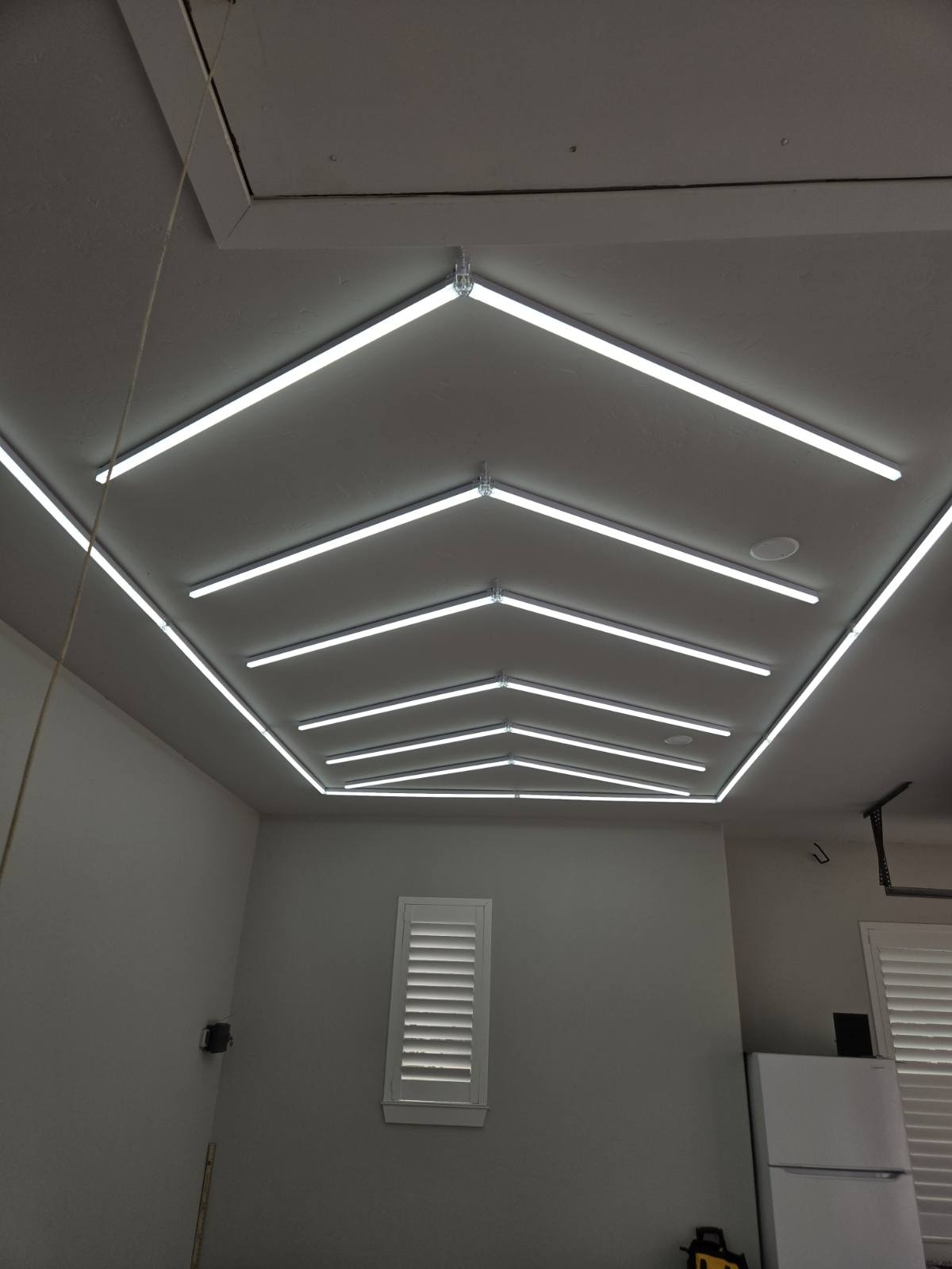 Chevron pattern LED lighting installed on a garage ceiling by Rieger Electric