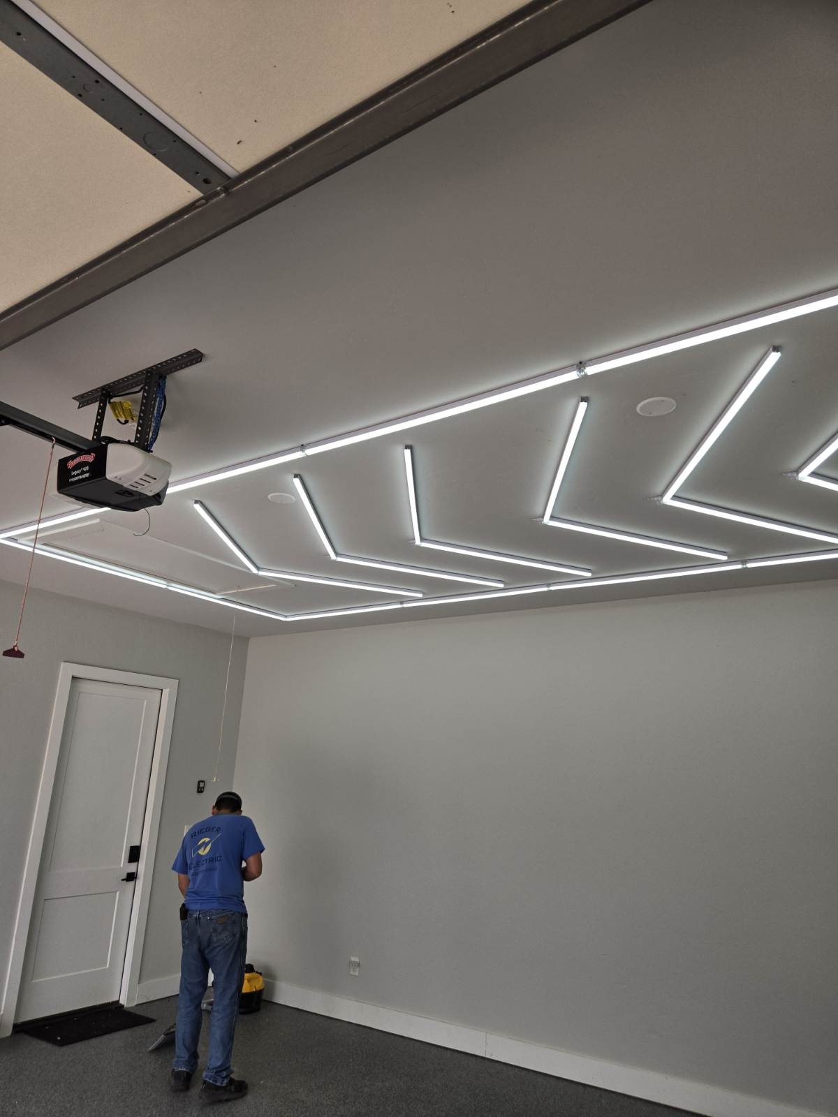 Custom LED grid lighting installed in a garage ceiling by Rieger Electric