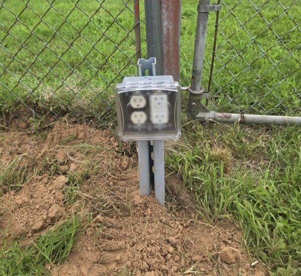 Weatherproof post mounted outdoor outlet installed by Rieger Electric