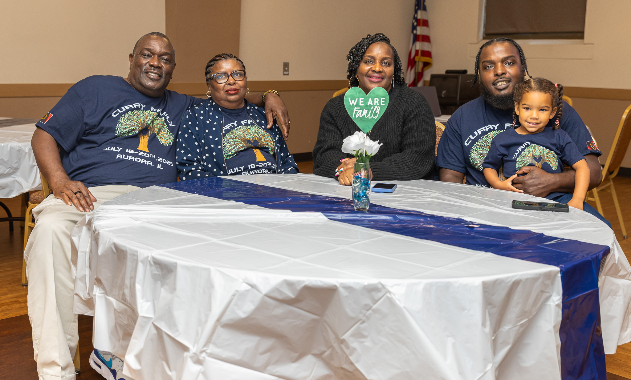 Curry family members gathered around the table smiling together