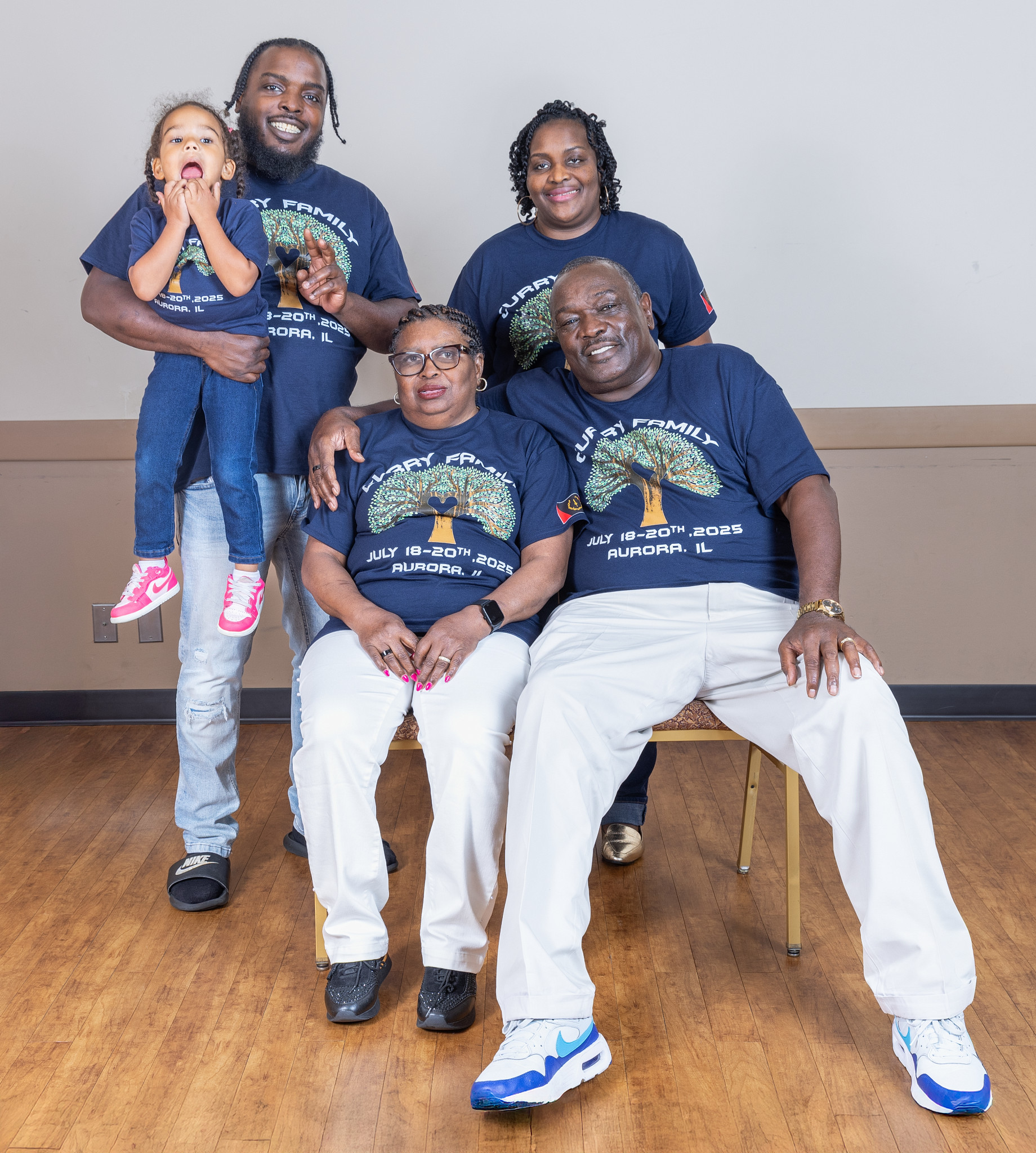 Multigenerational Curry family group portrait in reunion shirts