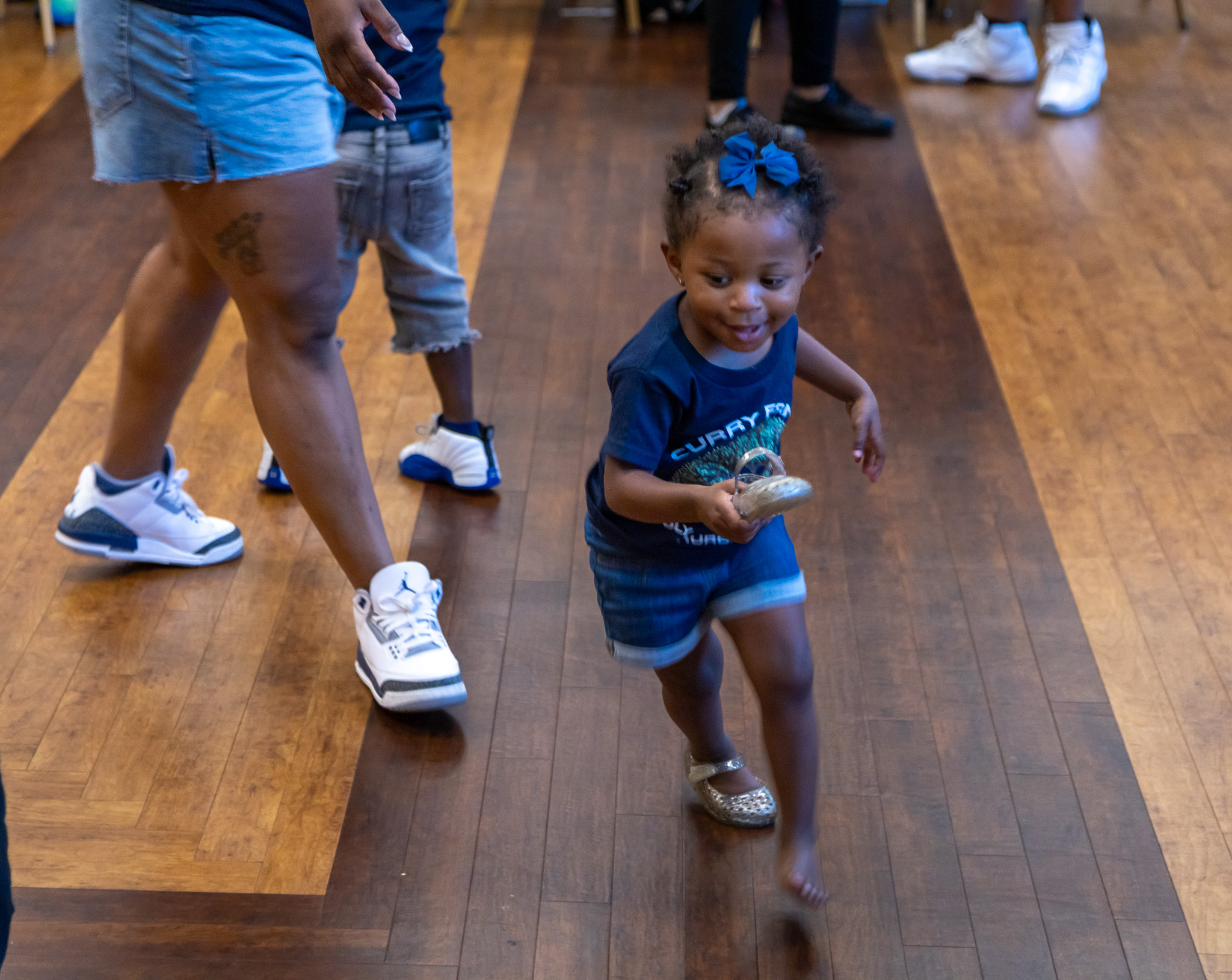 Young Curry family member smiling and running happily