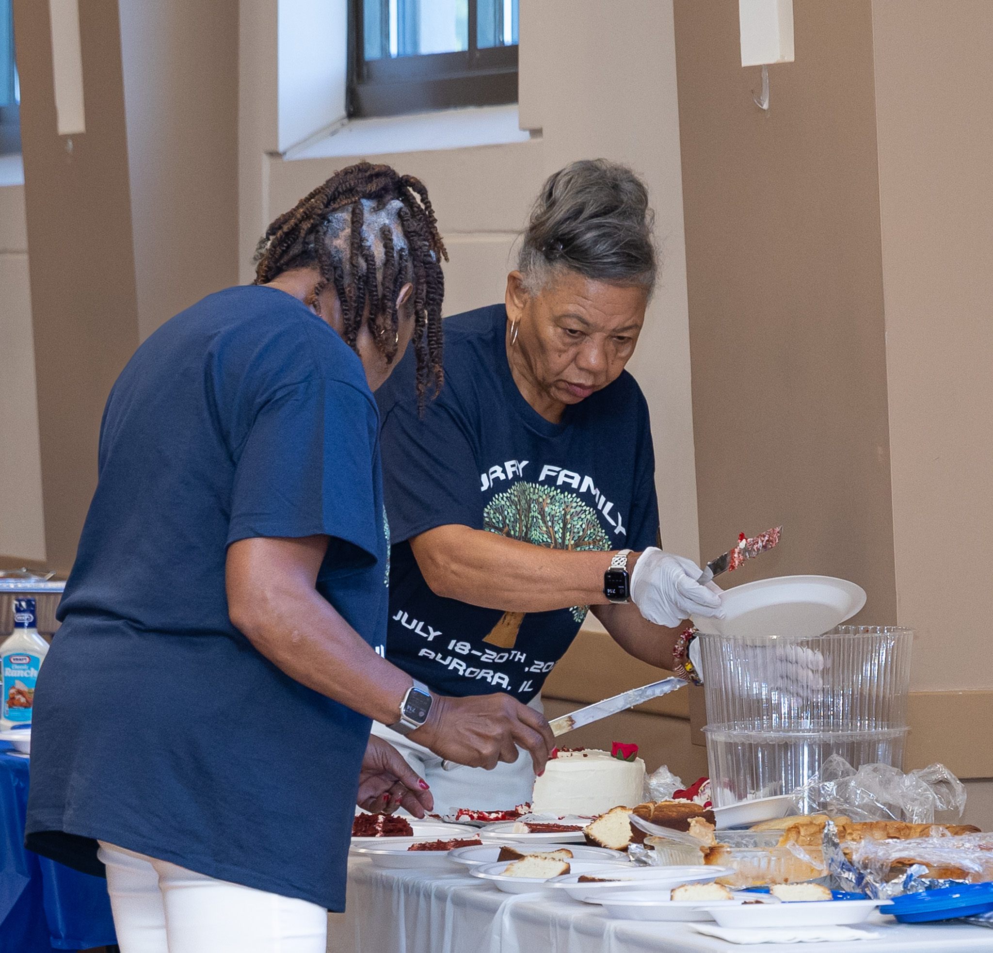 Curry family members serving dessert and cake at the reunion celebration